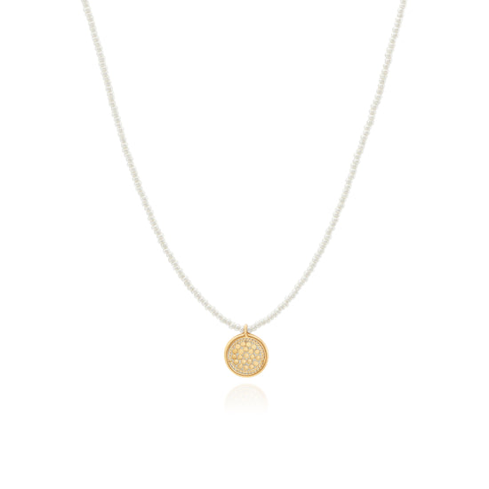 Seed pearl necklace with gold circular charm