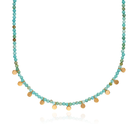 Necklace with turquoise and gold beads on a white background