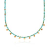 Necklace with turquoise and gold beads on a white background