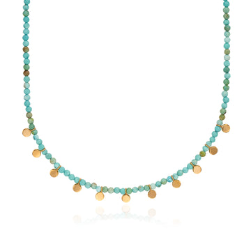 Necklace with turquoise and gold beads on a white background