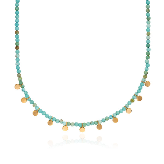 Necklace with turquoise and gold beads on a white background