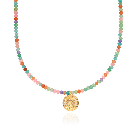 Necklace with multicolored beads and a gold pendant by Anna beck on a white background