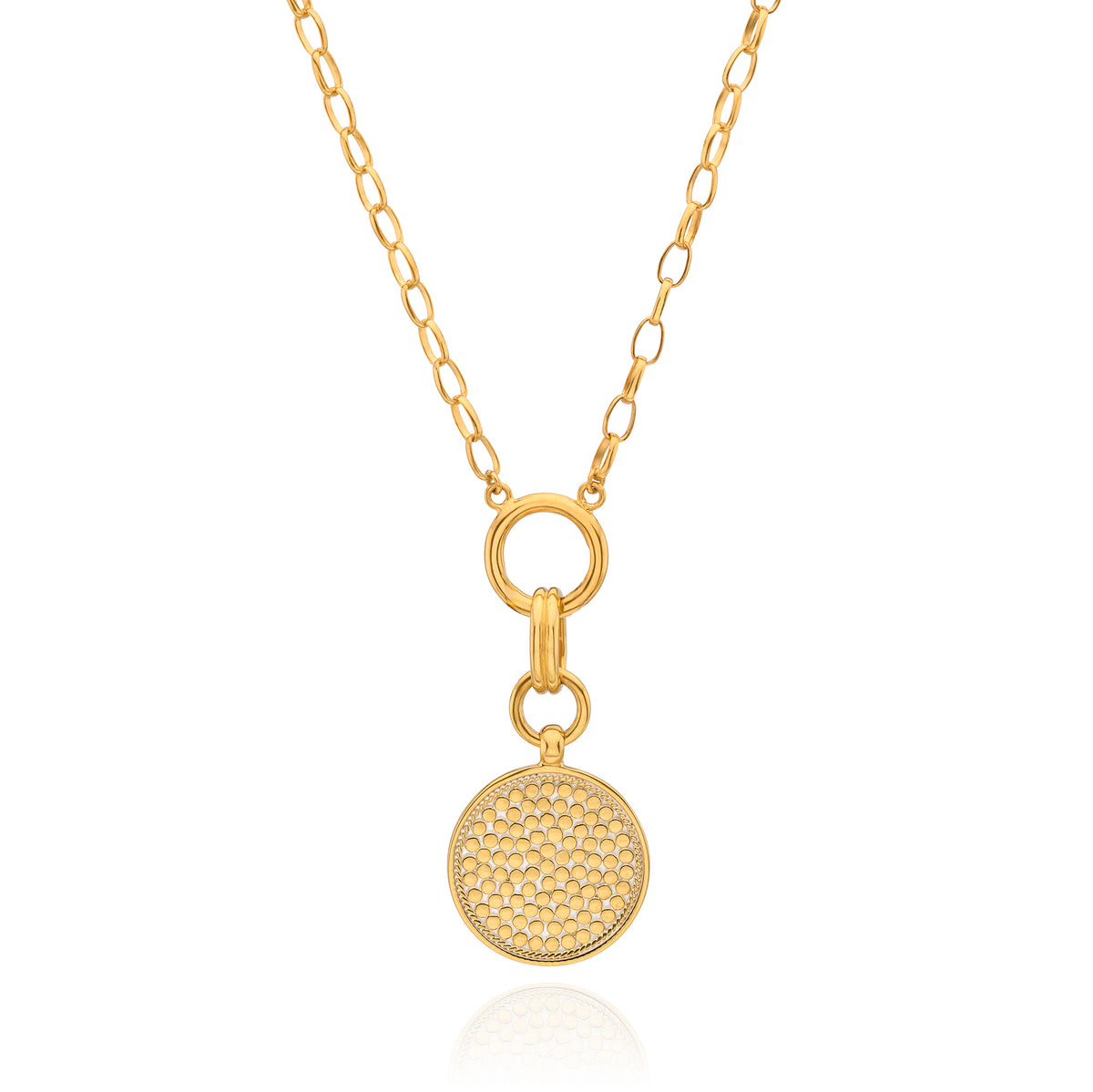 A gold chain necklace featuring a round, textured pavé-style disc pendant suspended from a ring clasp, shown on a clean white background with a subtle reflection.