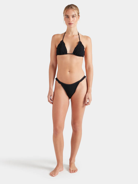 Woman wearing a black Hunza G bikini on a white background