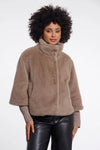 Woman wearing a brown fuzzy jacket on a white background