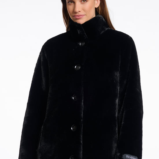 faux fur coat with high neck, black buttons and length just above the knee  close up