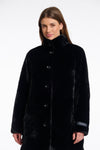 faux fur coat with high neck, black buttons and length just above the knee  close up