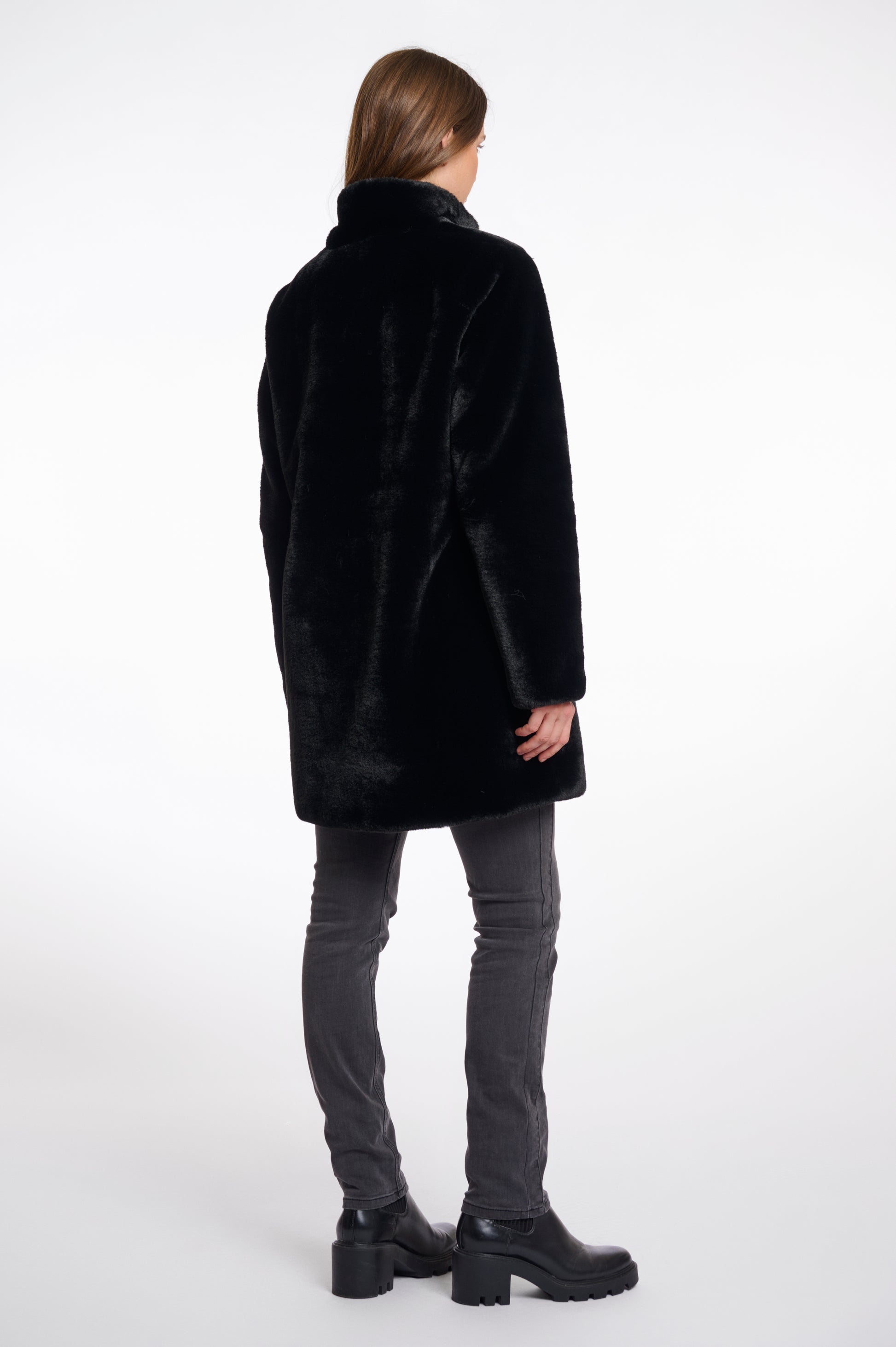 faux fur coat with high neck, black buttons and length just above the knee  rear view 