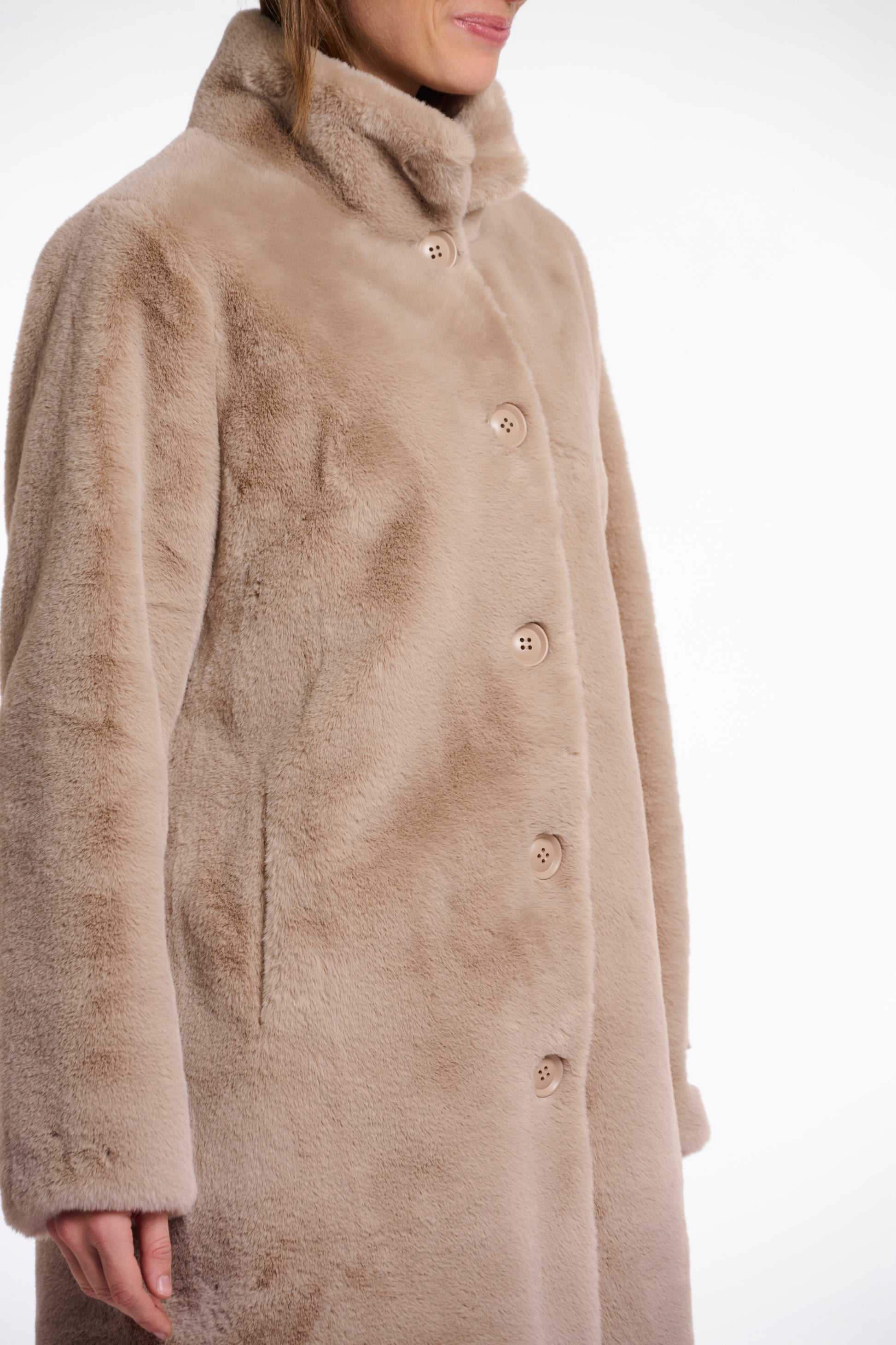 longer line beige faux fur coat with stand collar and large buttons from rino and pelle side view