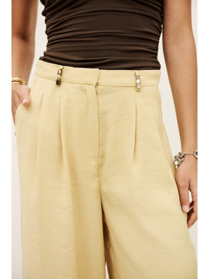 Detail image of straw coloured trousers with bead details