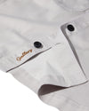 mens light grey cotton overshirt with black buttons and chest pockets close up