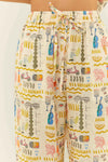 Linen drawstring trousers with a holiday inspired print close up