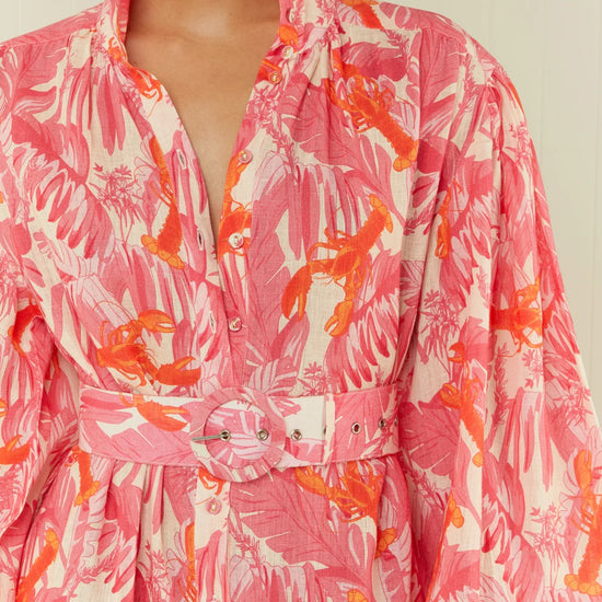 pink lobster print linen midi dress with long puff sleeves and belted waist  close up