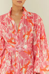 pink lobster print linen midi dress with long puff sleeves and belted waist  close up