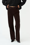straight leg corduroy dark brown jeans with mid rise  model shot