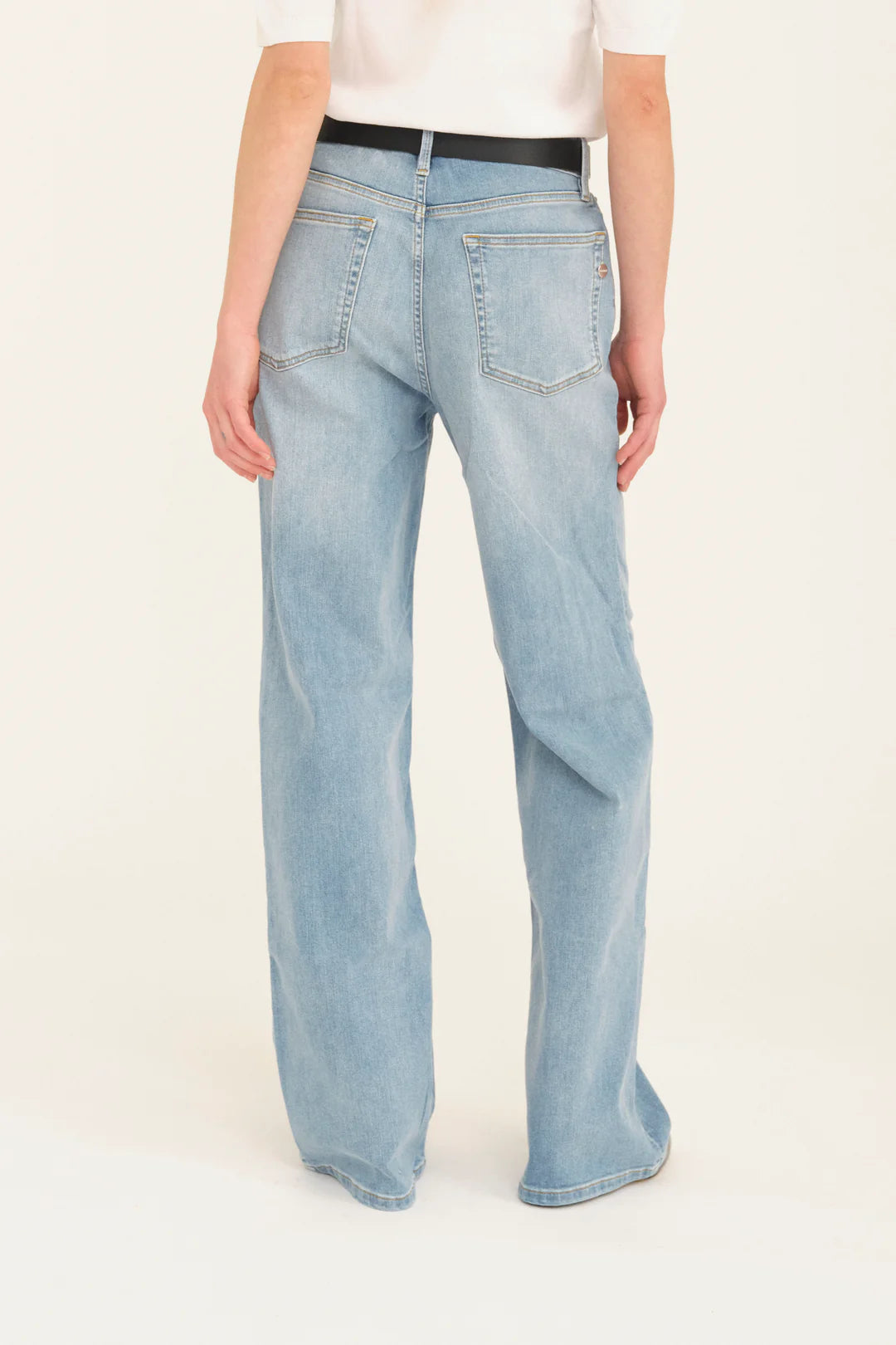 Rear view of pale wash denim on model