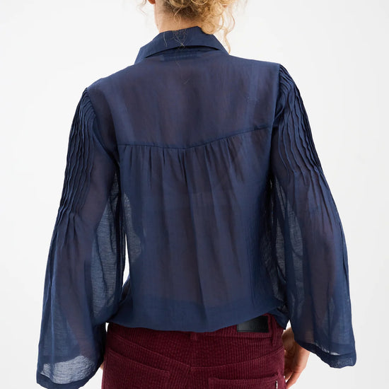 semi sheer blue pintuck shirt from pieszak rear view