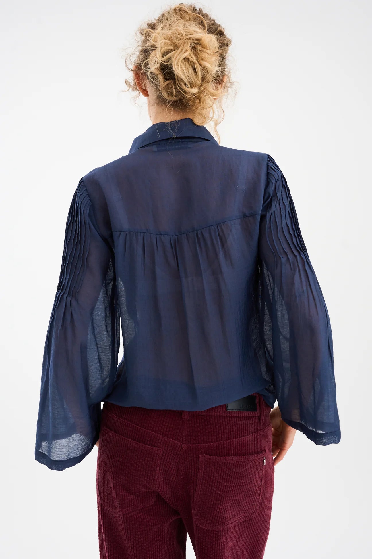 semi sheer blue pintuck shirt from pieszak rear view