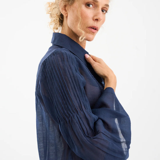 semi sheer blue pintuck shirt from pieszak side view