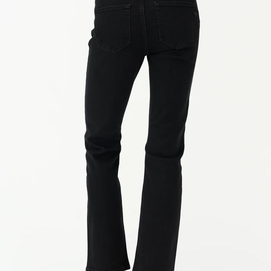 Black jeans worn by a person on a white background