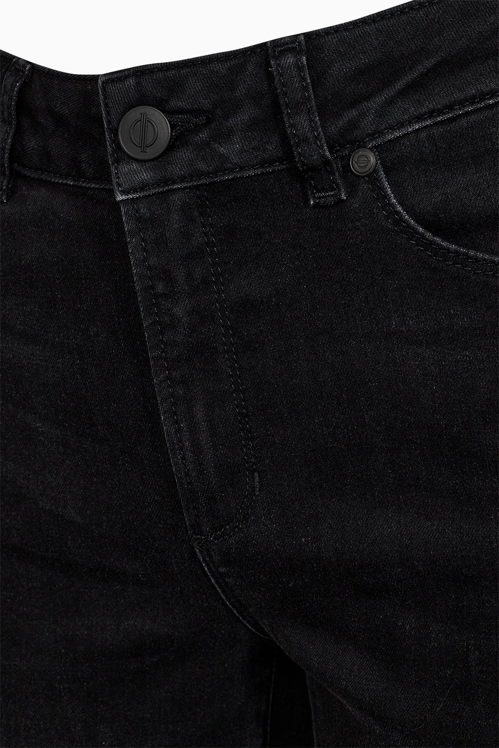 Close-up of black pants with a button and stitching detail on a white background