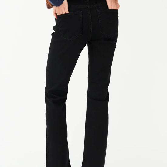 Person wearing black pants and a blue top on a white background