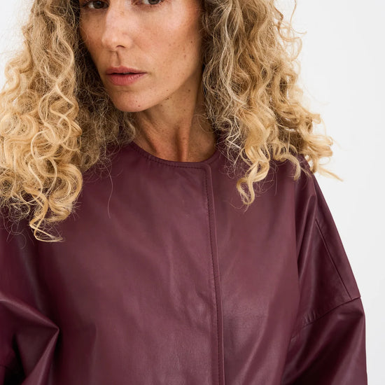 half sleeve concealed placket burgundy leather jacket from pieszak close up