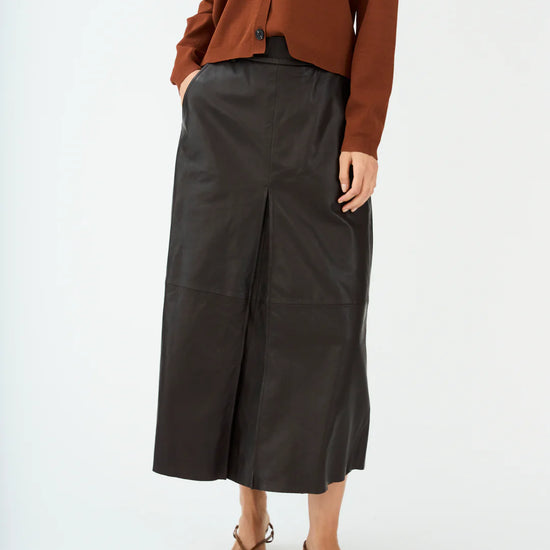 mid length chocolate brown leather pleated skirt with belt loops model shot
