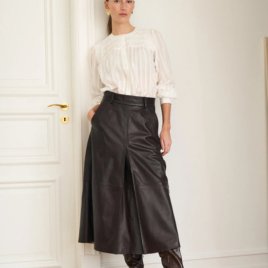 mid length chocolate brown leather pleated skirt with belt loops model shot