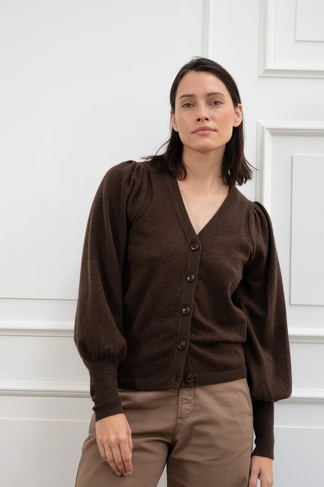 Brown puff sleeve cardigan with a v neck styled with pale brown trousers