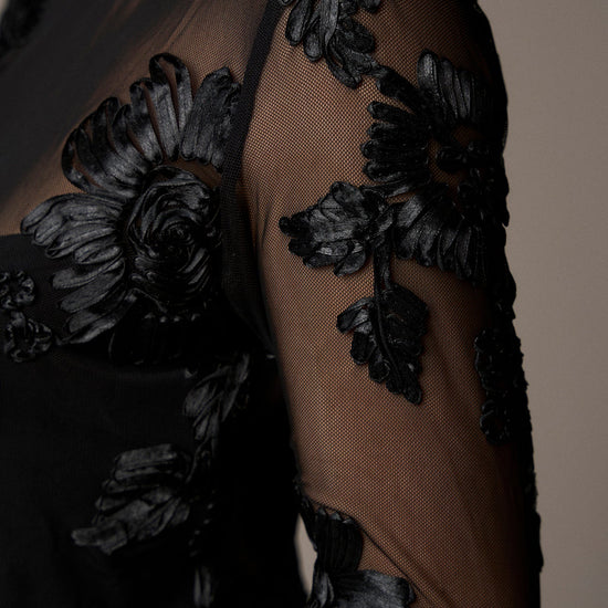 black mesh sheer blouse with fitted bodice and embroidered floral stitching from pieszak  model shot close up