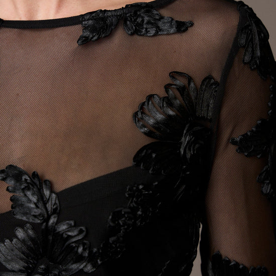 black mesh sheer blouse with fitted bodice and embroidered floral stitching from pieszak  model shot close up