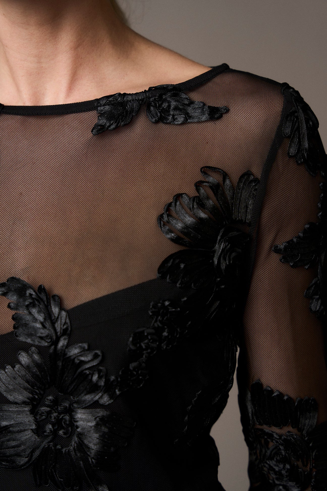 black mesh sheer blouse with fitted bodice and embroidered floral stitching from pieszak  model shot close up