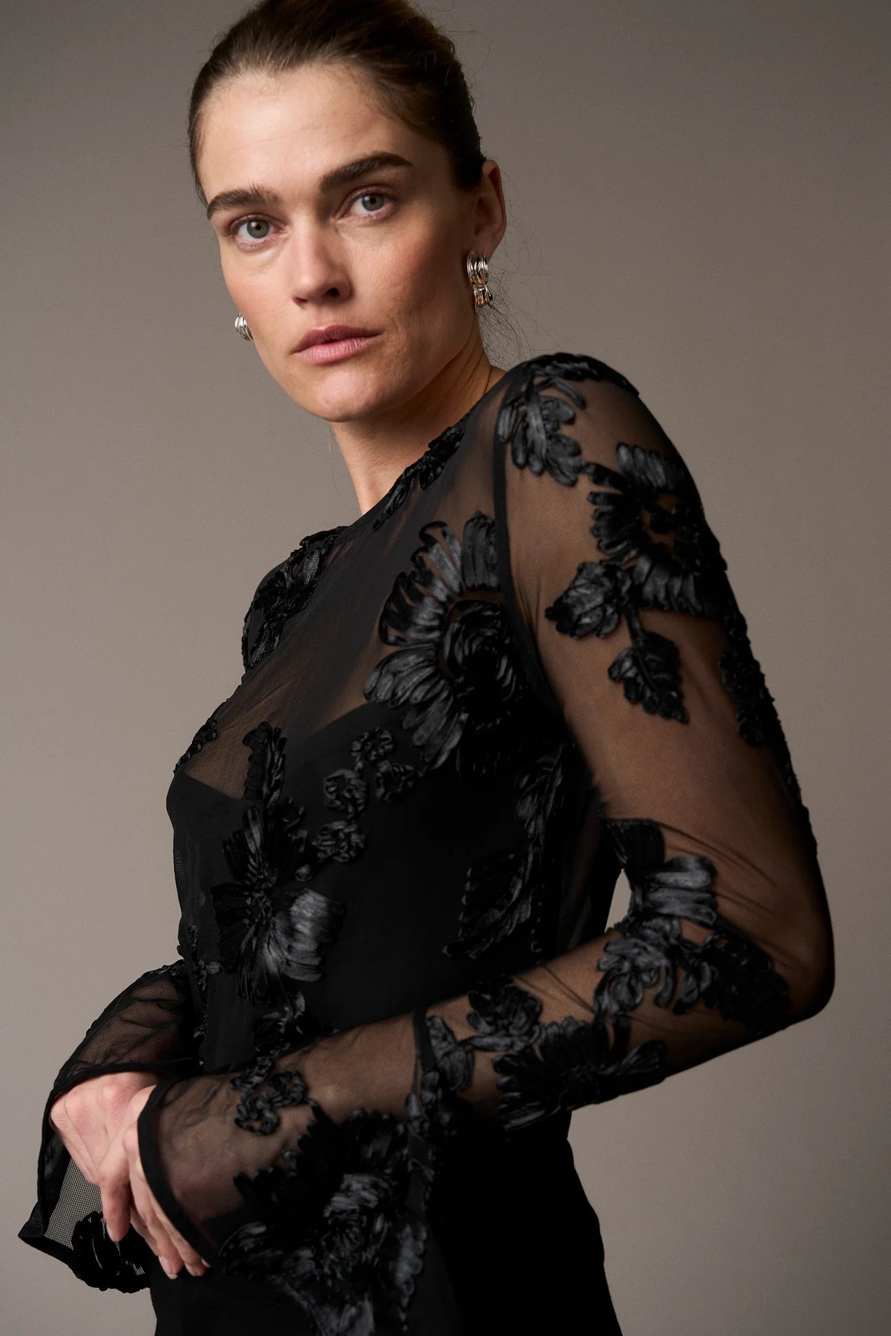 black mesh sheer blouse with fitted bodice and embroidered floral stitching from pieszak  model shot side view 