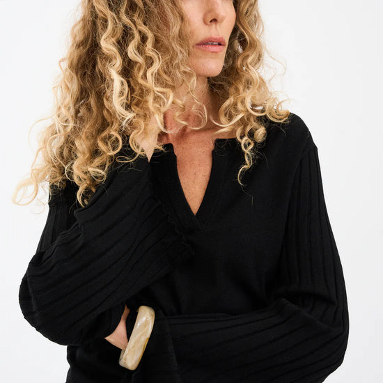 black v neck metallic top with ribbed wide sleeves from pieszak model shot