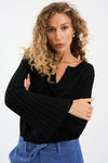 black v neck metallic top with ribbed wide sleeves from pieszak model shot