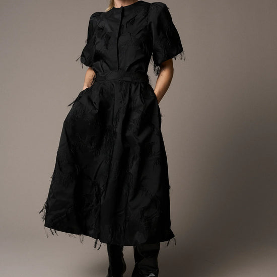 Black textured full skirt worn with matching jacket from Pieszak