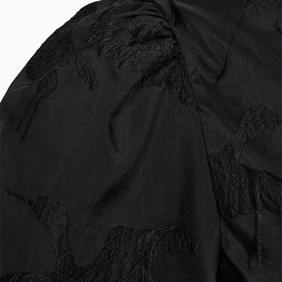 close up of black fabric with fringe details