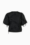 Rear view of black short sleeve jacket with fringe details