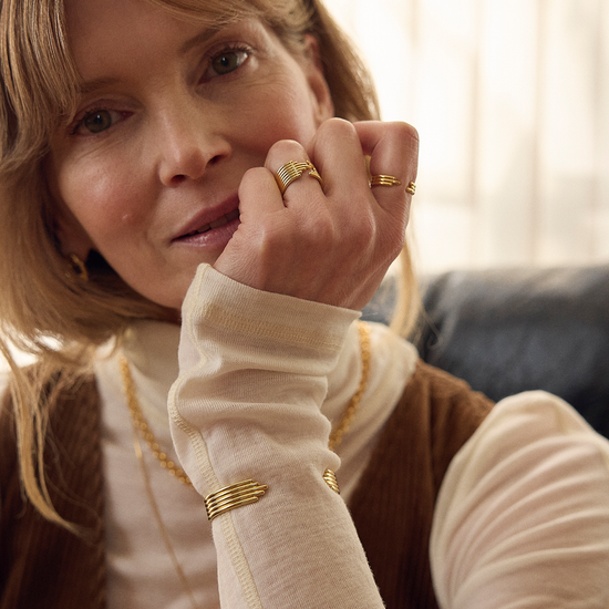 stacked gold circular bangle with different sized pieces from rachel jackson model shot