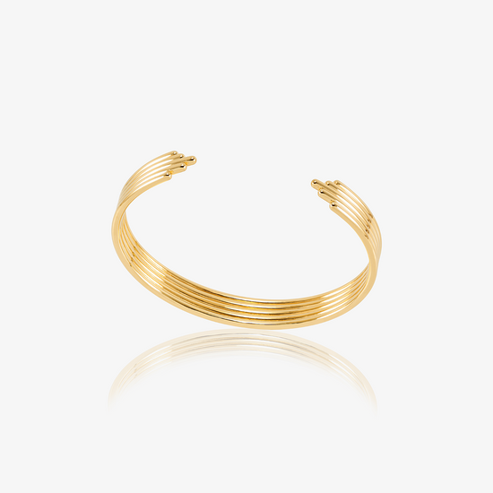 stacked gold circular bangle with different sized pieces from rachel jackson