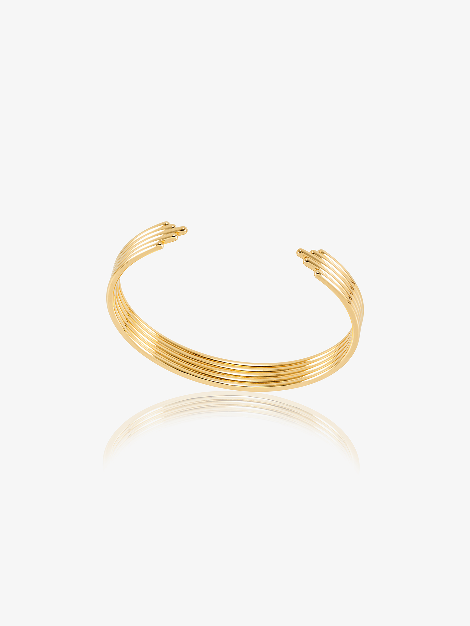 stacked gold circular bangle with different sized pieces from rachel jackson