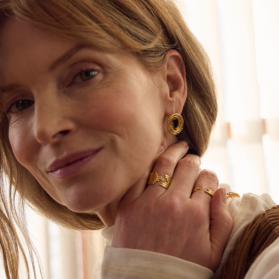 circular gold front facing earring which fit inside each other from rachel jackson  model shot