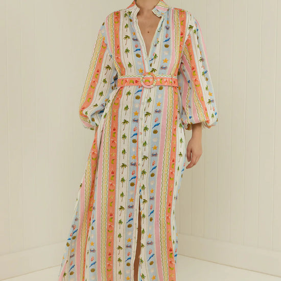  maxi length linen dress with tropical print, puffy long sleeves and belted waist  model shot