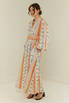 maxi length linen dress with tropical print, puffy long sleeves and belted waist side view