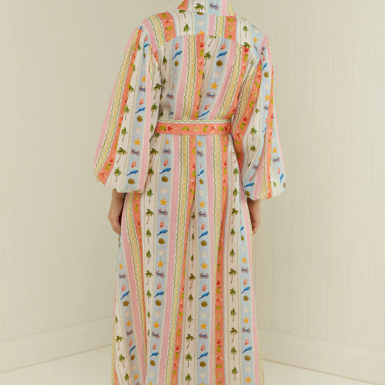 maxi length linen dress with tropical print, puffy long sleeves and belted waist rear view