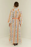 maxi length linen dress with tropical print, puffy long sleeves and belted waist rear view