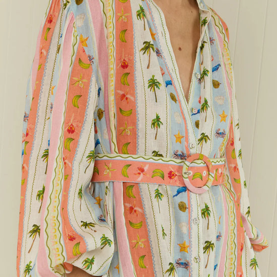 maxi length linen dress with tropical print, puffy long sleeves and belted waist close up