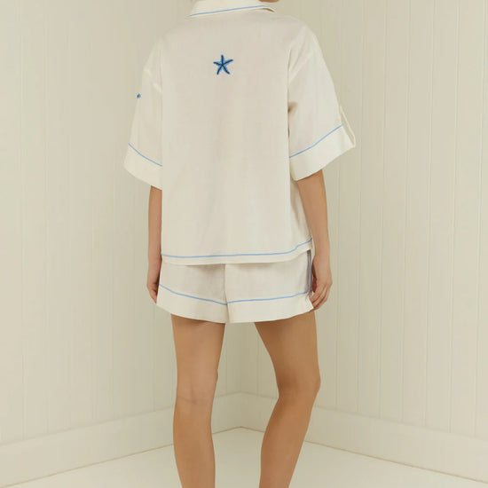 white shorts with blue starfish with elasticated drawstring waist  rear view 