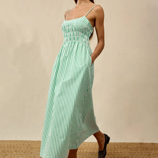 Woman wearing white and green stripe dress from rails